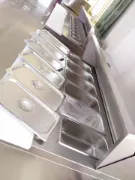 Picture of Stainless steel pizza and salad bar fridge for commercial use.