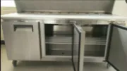 Picture of Stainless steel pizza and salad bar fridge for commercial use.